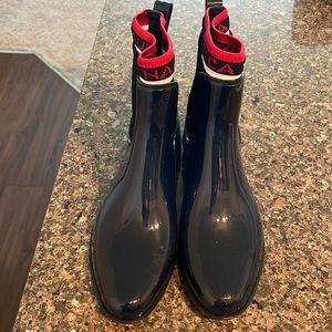 Waterproof ankle-high boots. Red, white and blue stretchy trim and side panel.